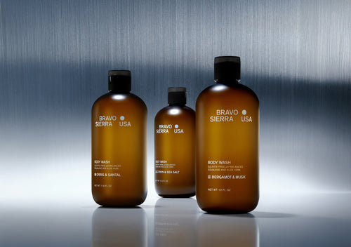 Bravo Sierra body wash trio in amber bottles, featuring Orris & Santal and Bergamot & Musk scents.