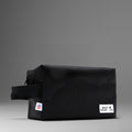 Black toiletry bag made of durable material with zipper closure and branded logo for travel convenience.