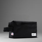 Black toiletry bag made of durable material with zipper closure and branded logo for travel convenience.