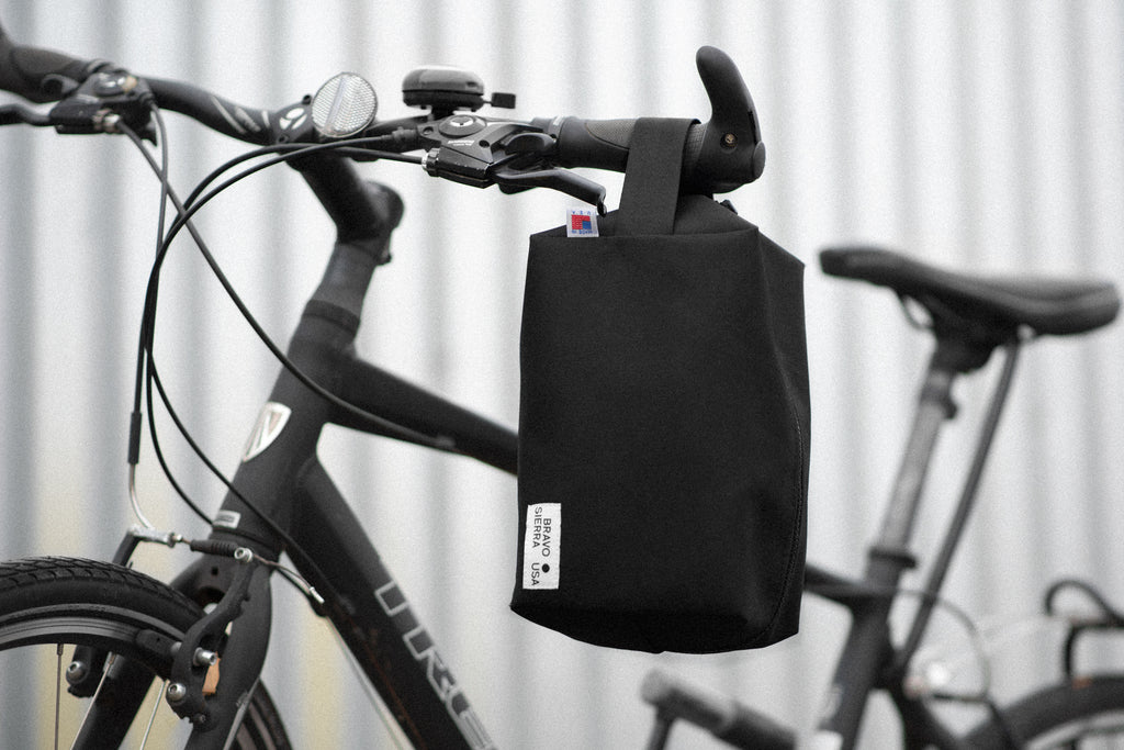 Black bike handlebar bag, durable material, perfect for cycling essentials, stylish and functional design.