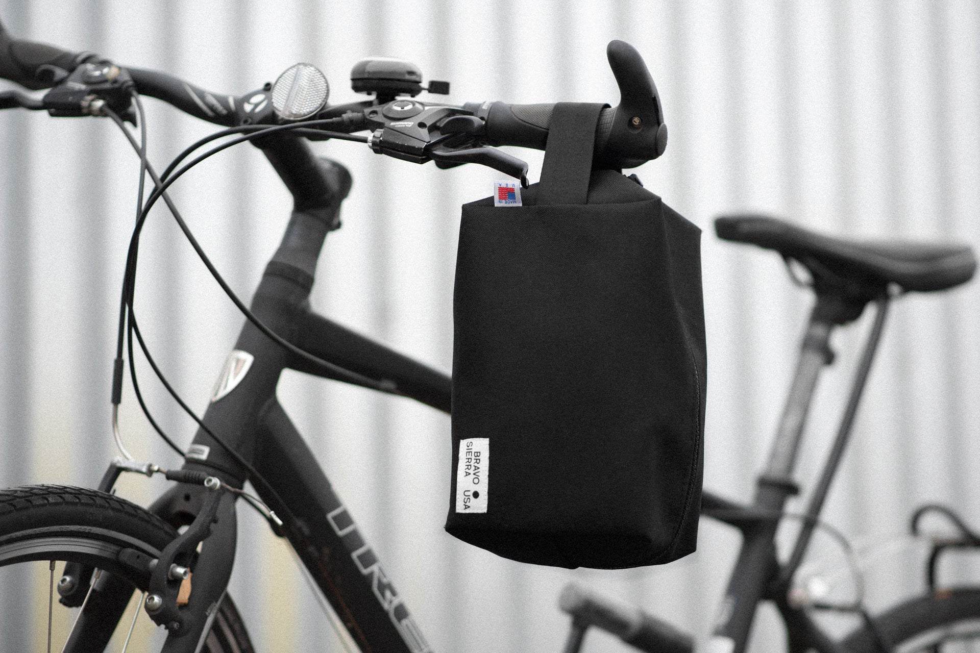 Black bike handlebar bag, durable material, perfect for cycling essentials, stylish and functional design.